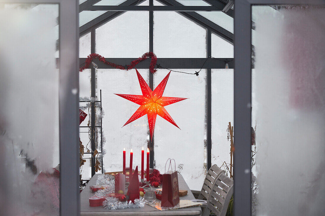 Red Christmas star and decorations on table