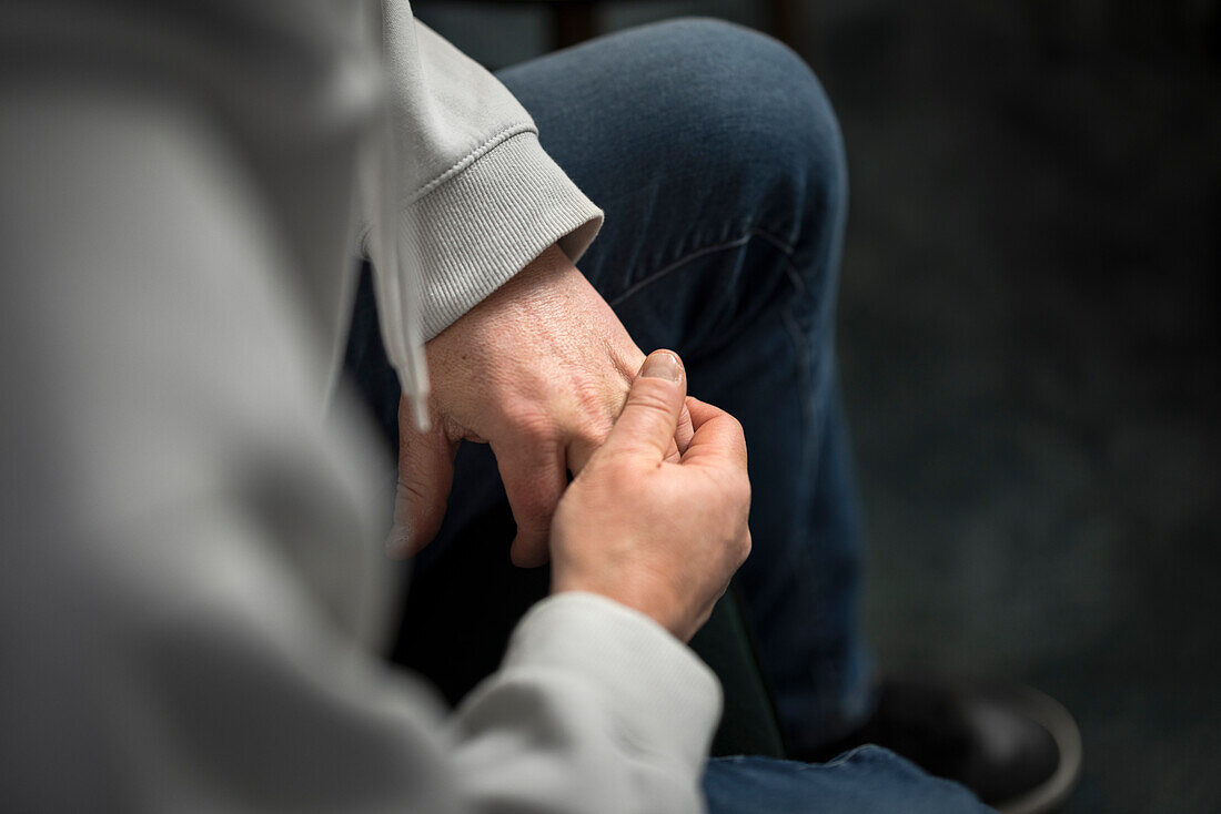 Close-up of man wringing hands