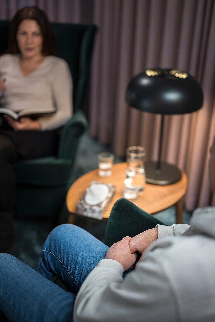 Man wringing hands at therapy session