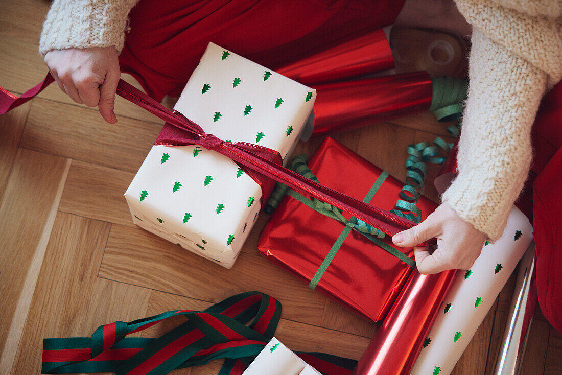 Woman's hands packing Christmas presents