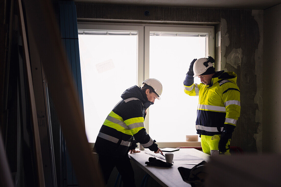 Engineers talking at building site