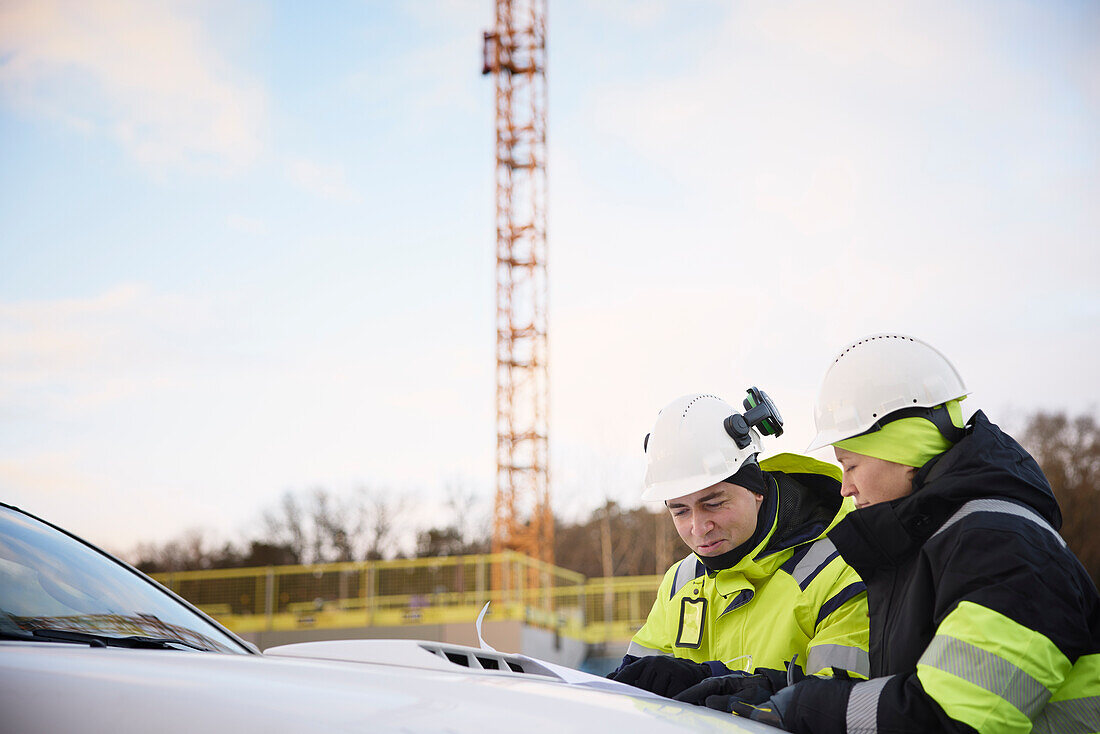 Engineers talking at building site