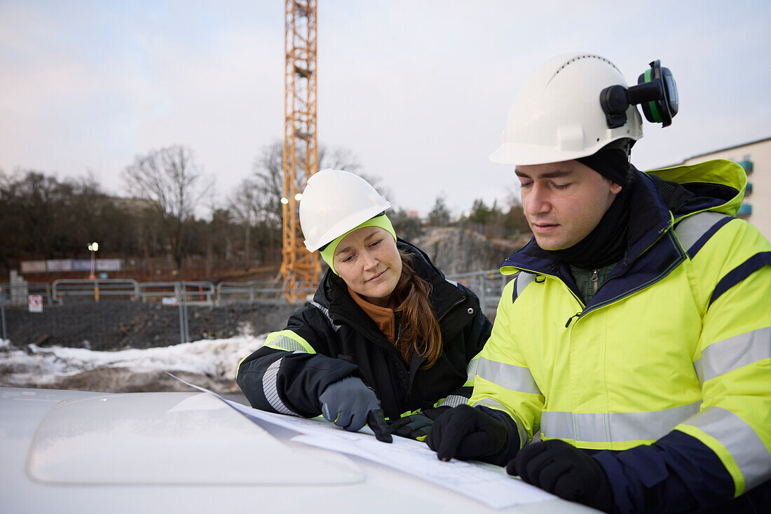 Engineers talking at building site