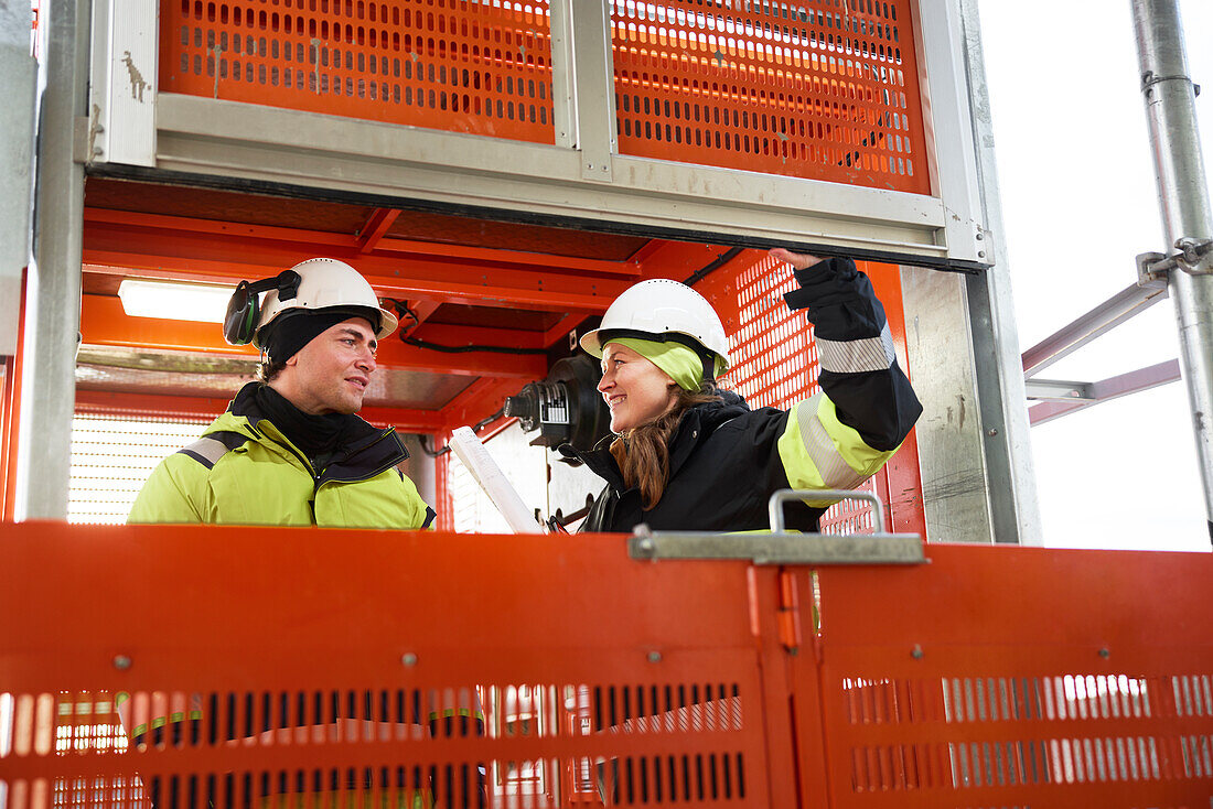 Engineers talking at building site