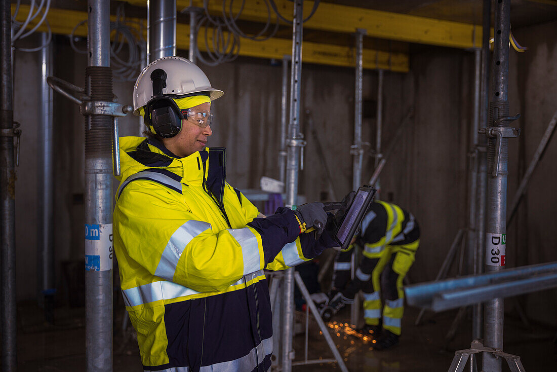 Engineer at building site using digital tablet