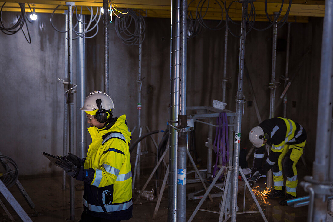 Engineer at building site using digital tablet