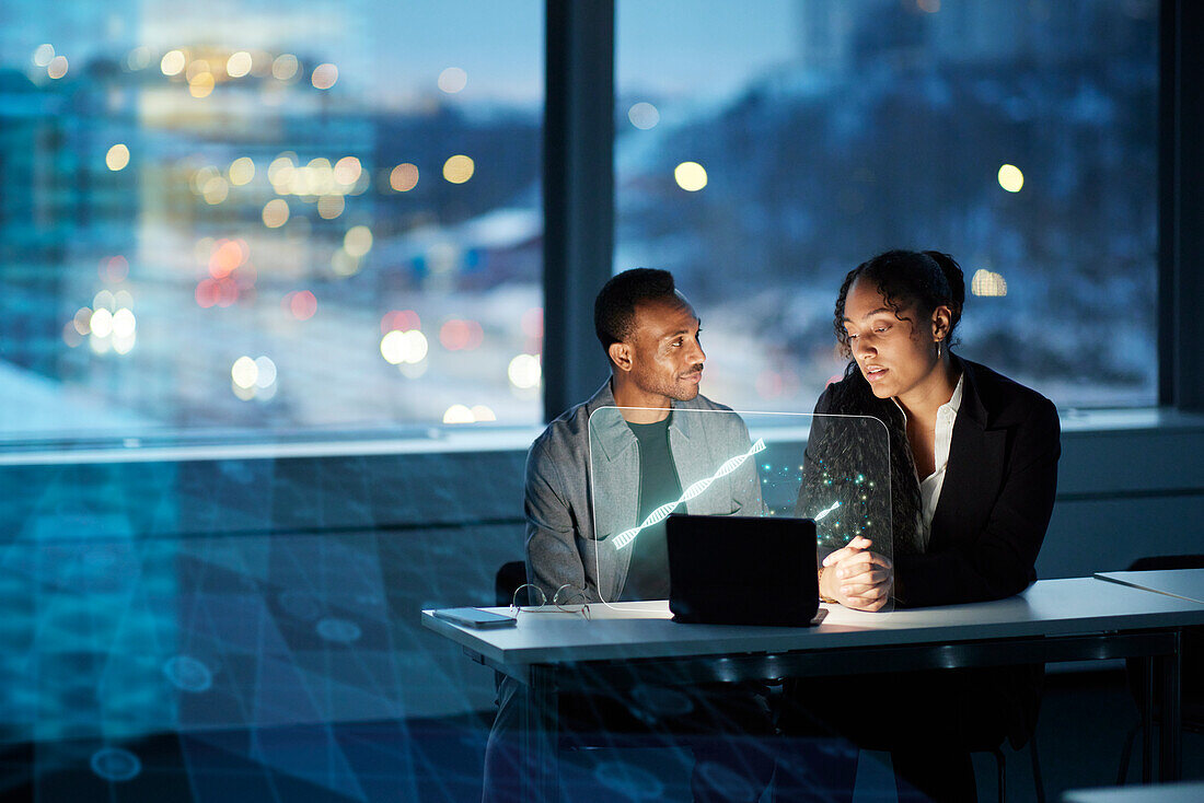 Two young business people working together in office