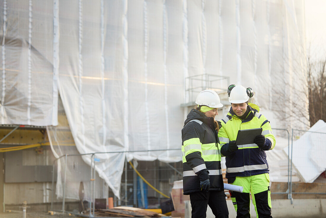 Engineers talking at building site