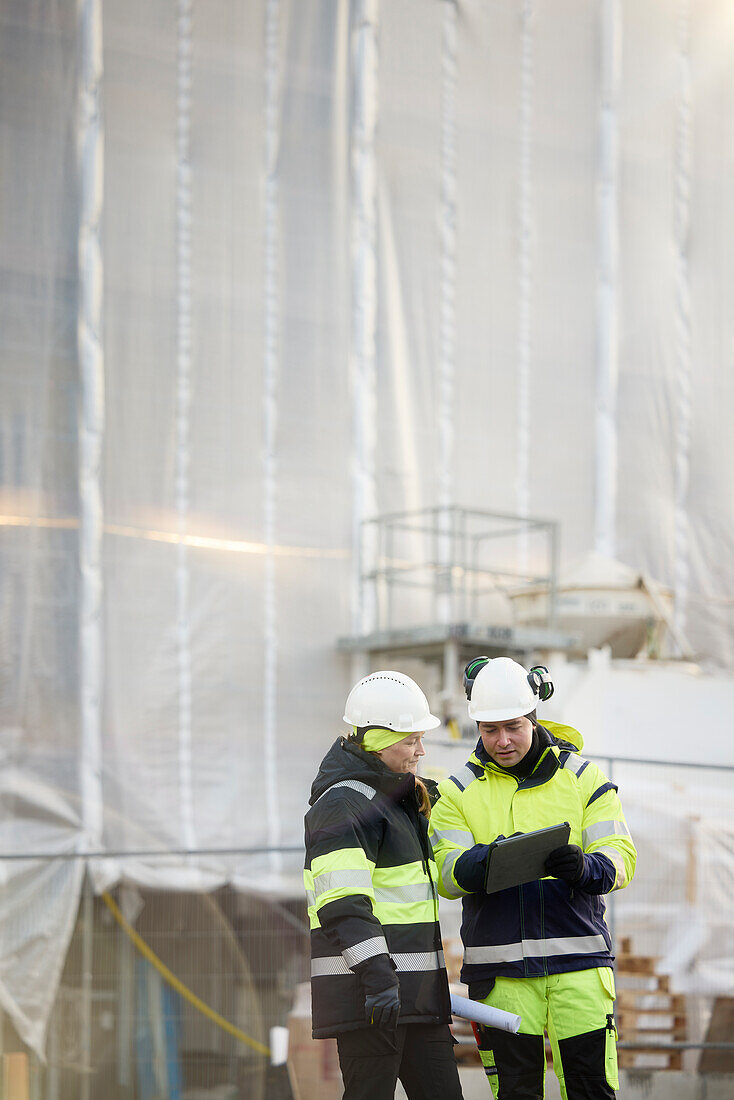 Engineers talking at building site