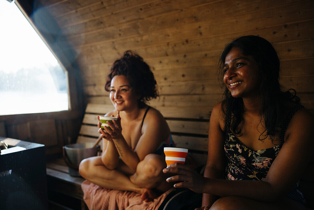 Female friends talking in sauna