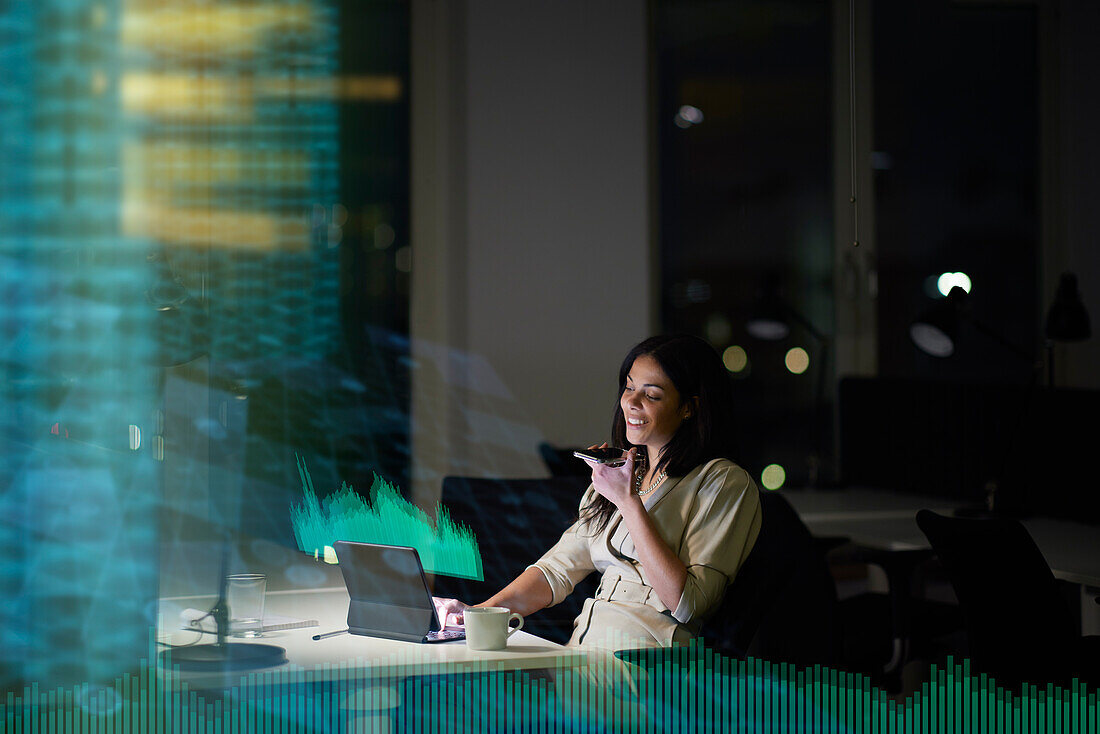 Young businesswoman working in office at night