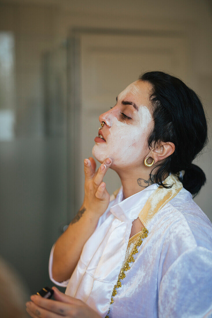 Woman painting face for Halloween