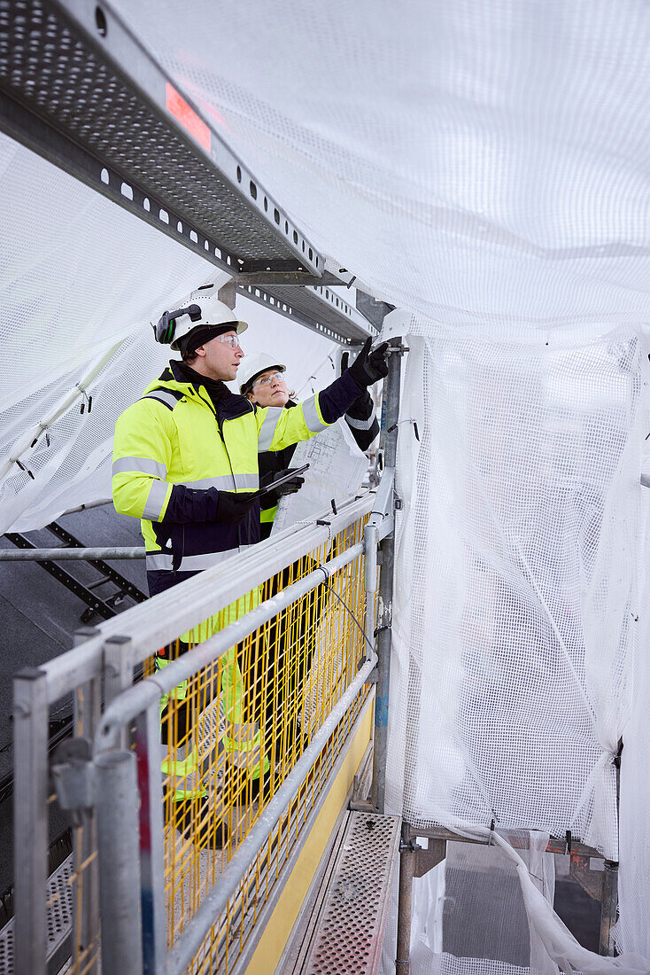 Engineers talking at building site