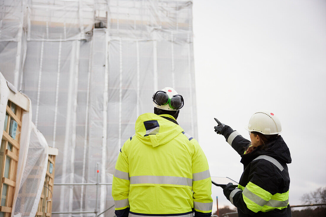 Engineers talking at building site