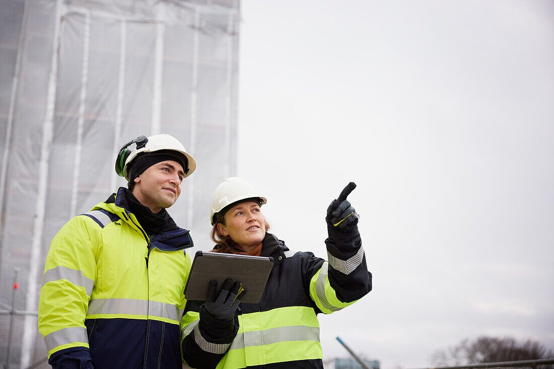 Engineers talking at building site