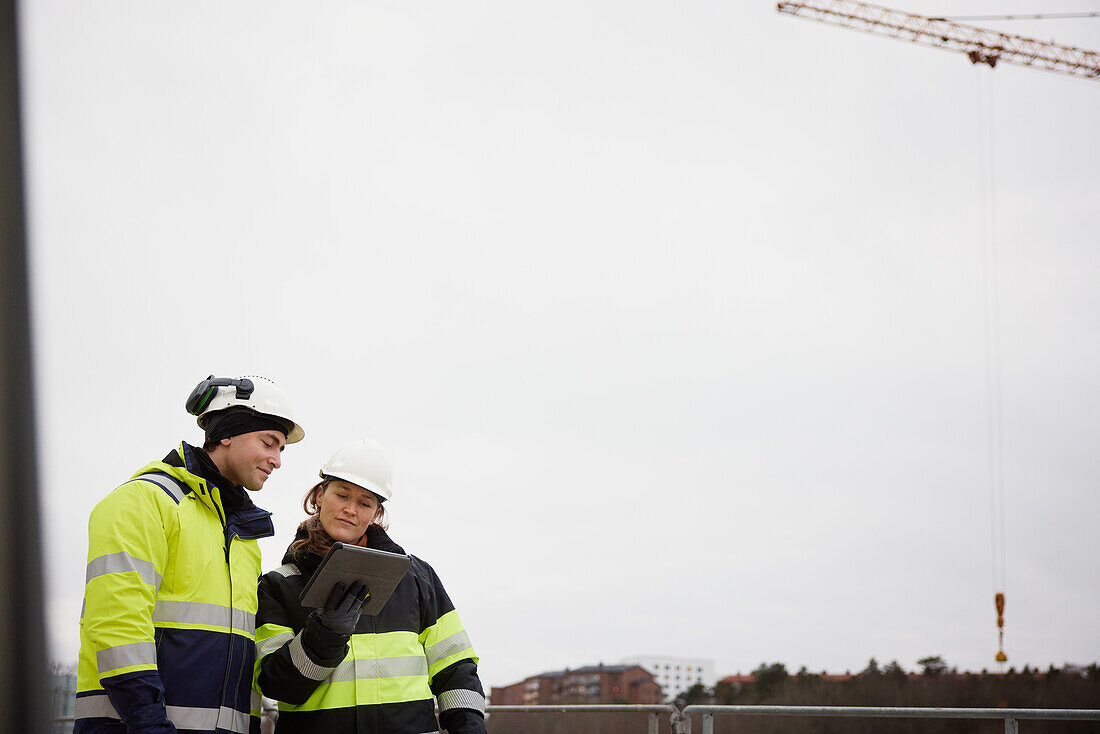 Engineers talking at building site