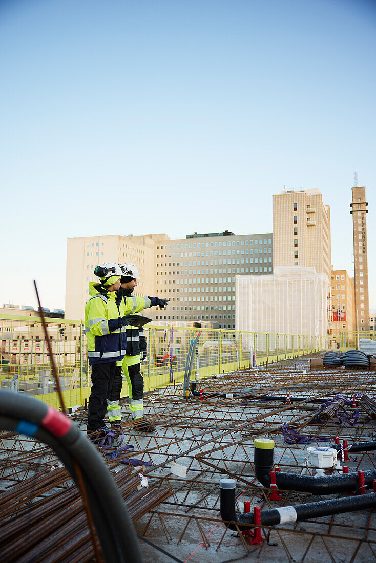 Two engineers working at construction site