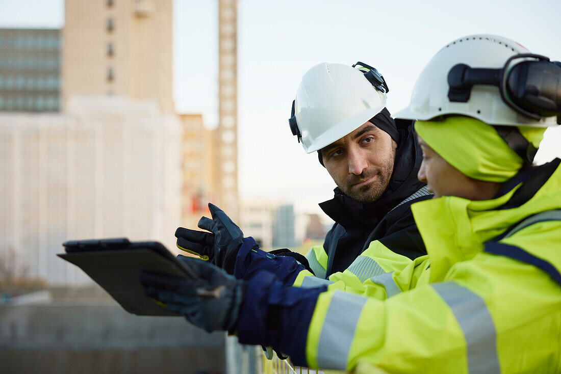 Two engineers working at construction site