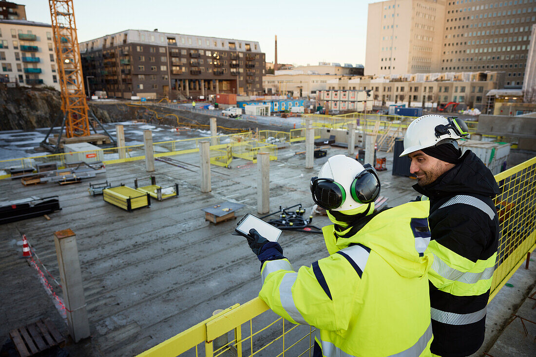 Two engineers working at construction site