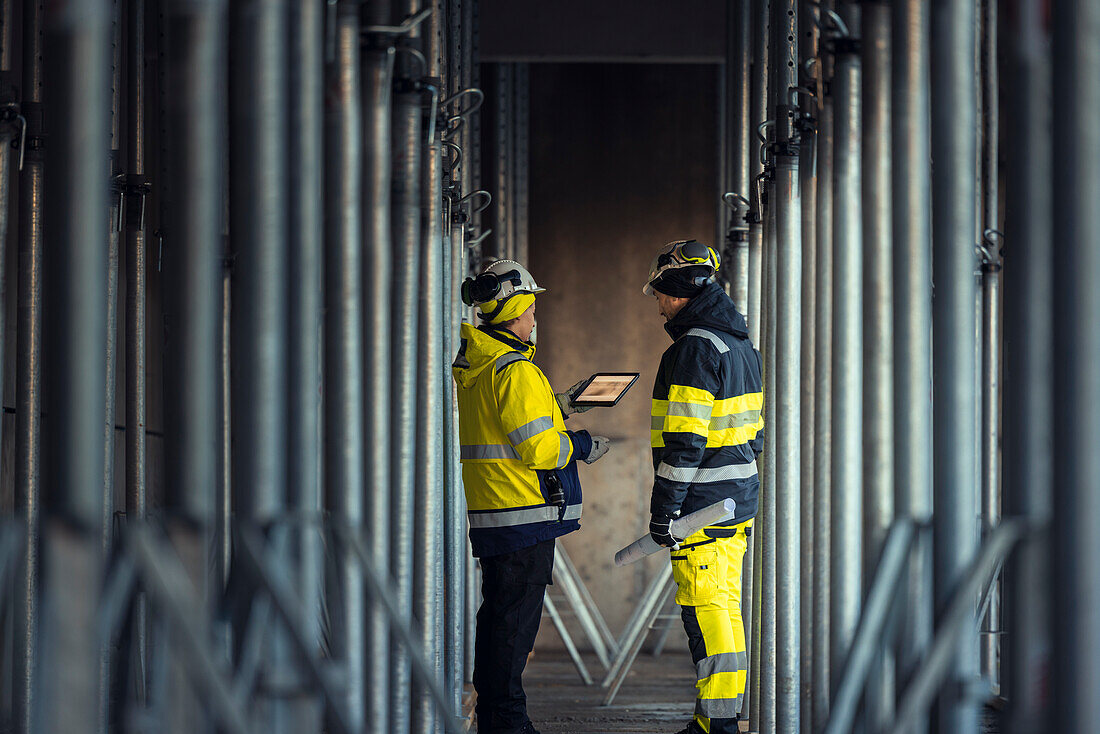 Engineers talking at building site