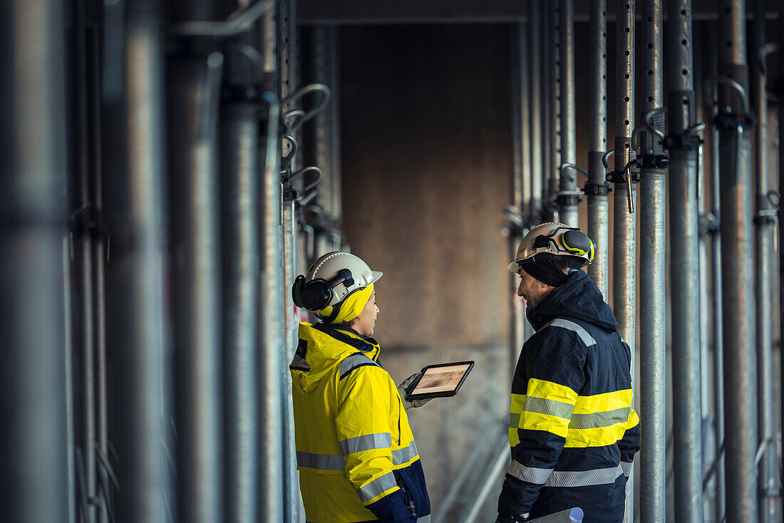 Engineers talking at building site