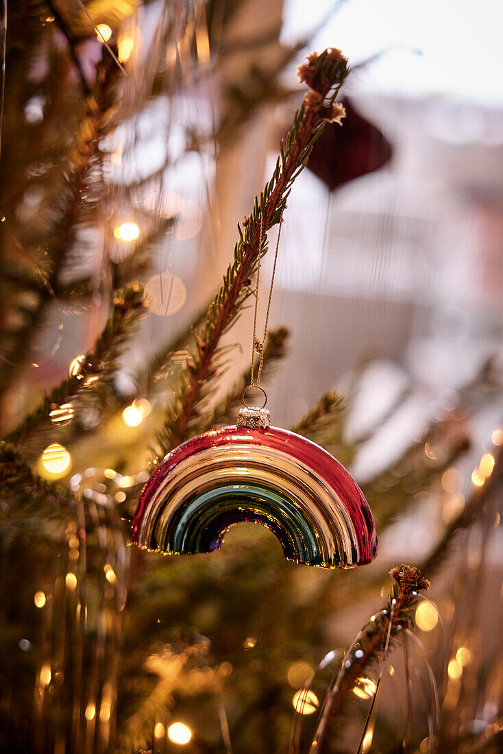 Rainbow ornament hanging on Christmas tree