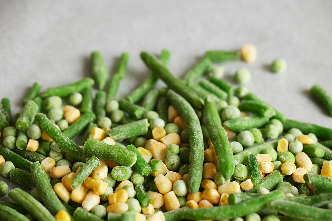 Heap of frozen green beans, peas, and corn