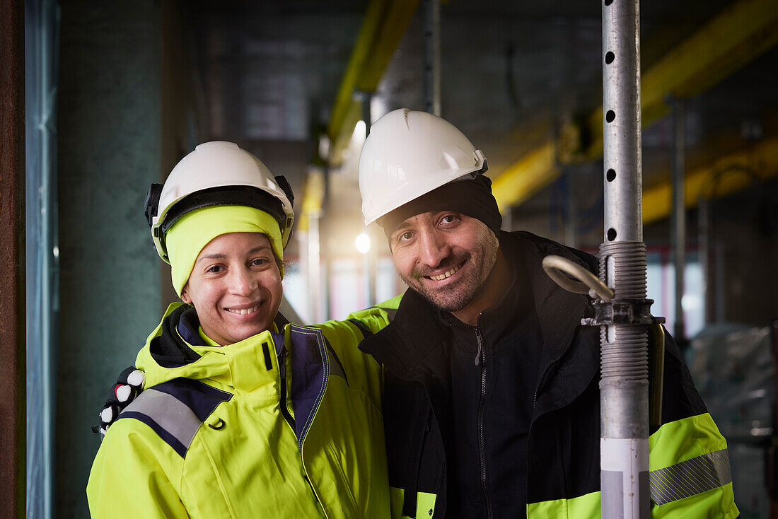 Portrait of smiling engineers at construction site