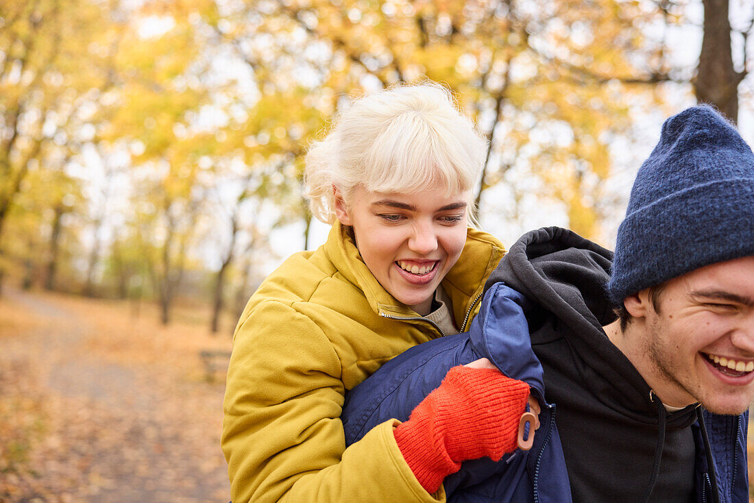 Happy young friends having autumn walk