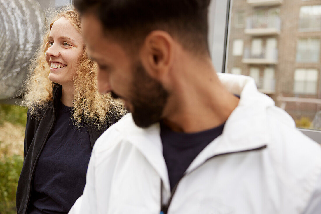 Smiling man and woman together looking away