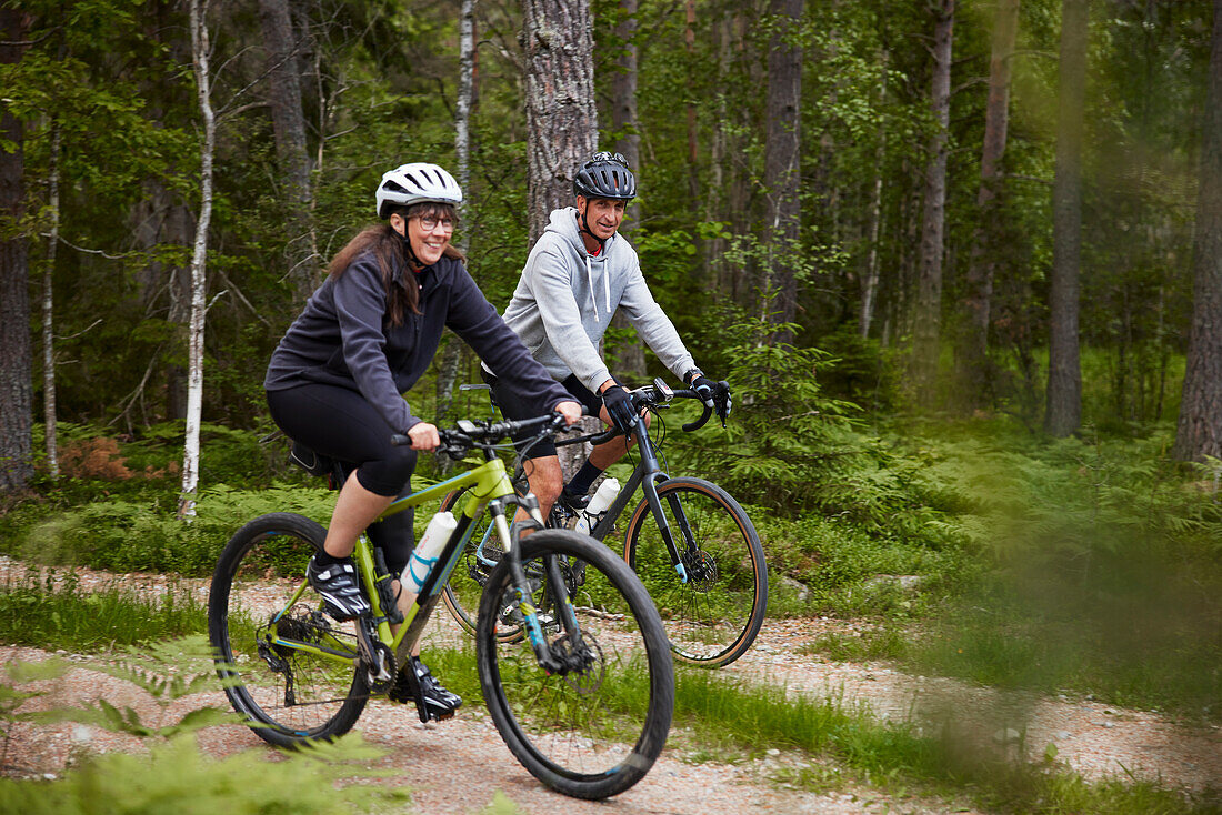 View of people cycling through forest