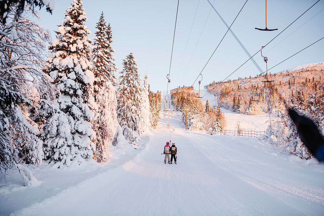 View of skiers on ski lift