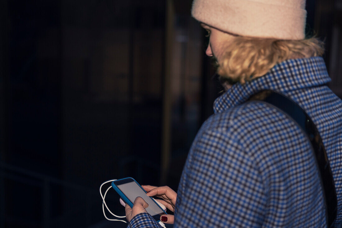 Young woman using phone outdoors