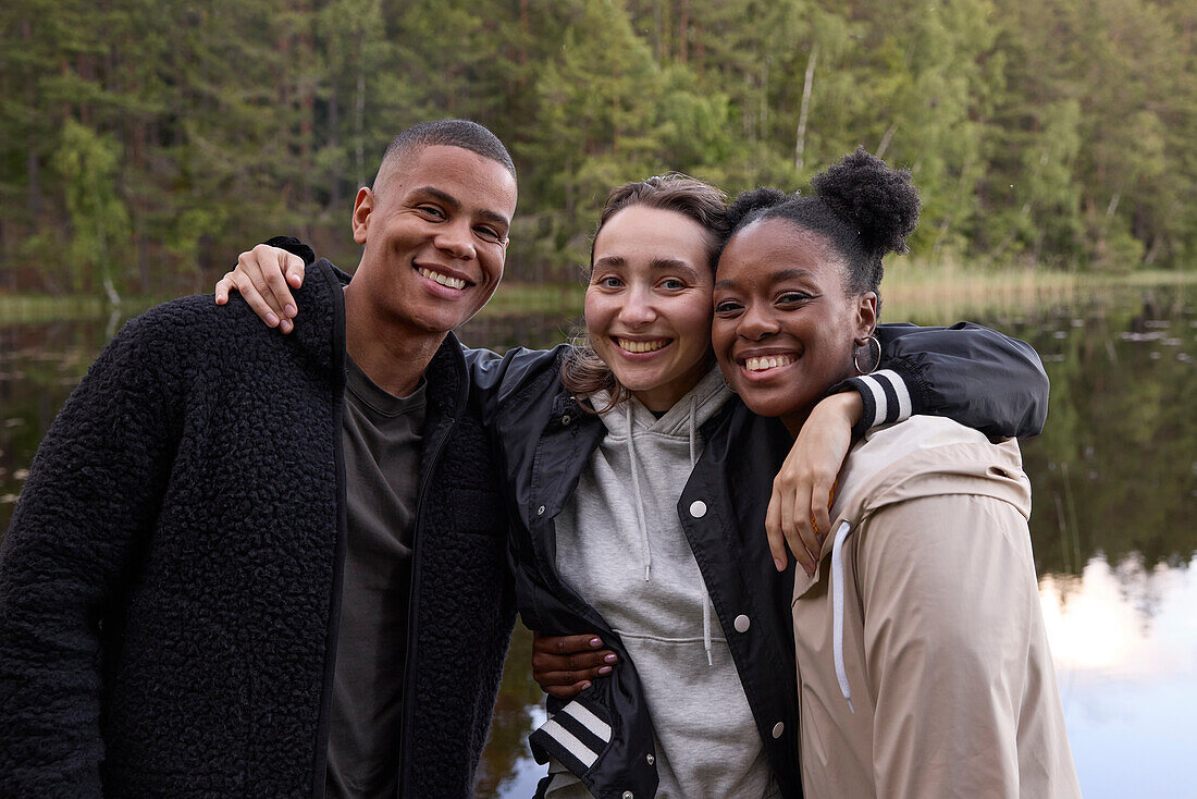 Smiling friends looking at camera