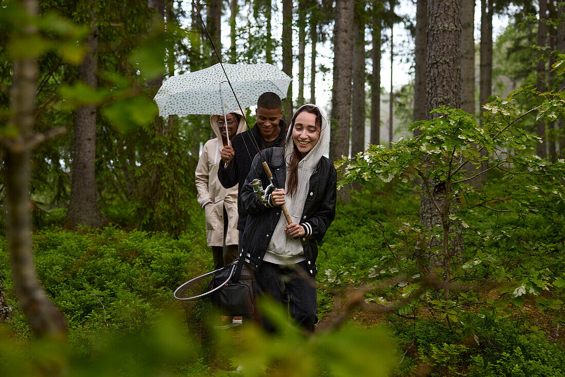 Friends walking through forest