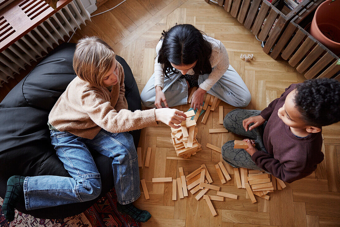 Children playing jenga at home
