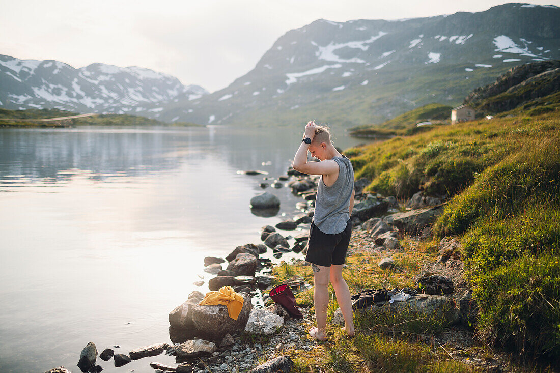 Woman standing at lake in mountains