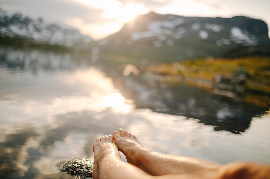 View of person's feet at water