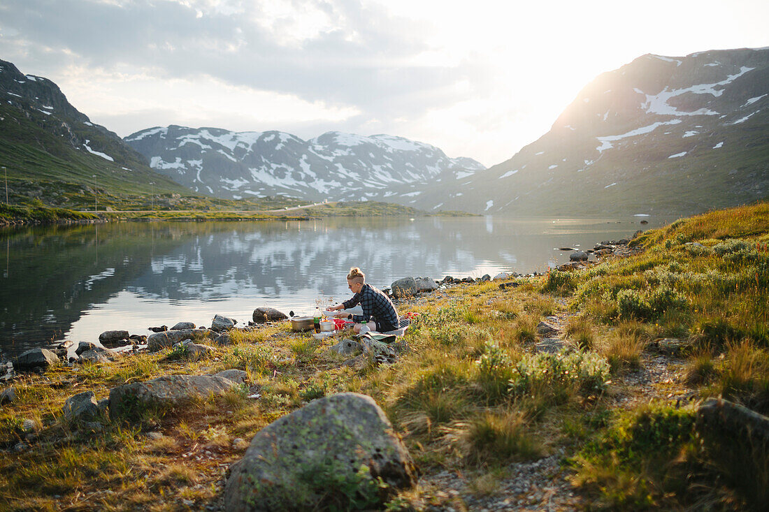 Woman camping at mountain lake