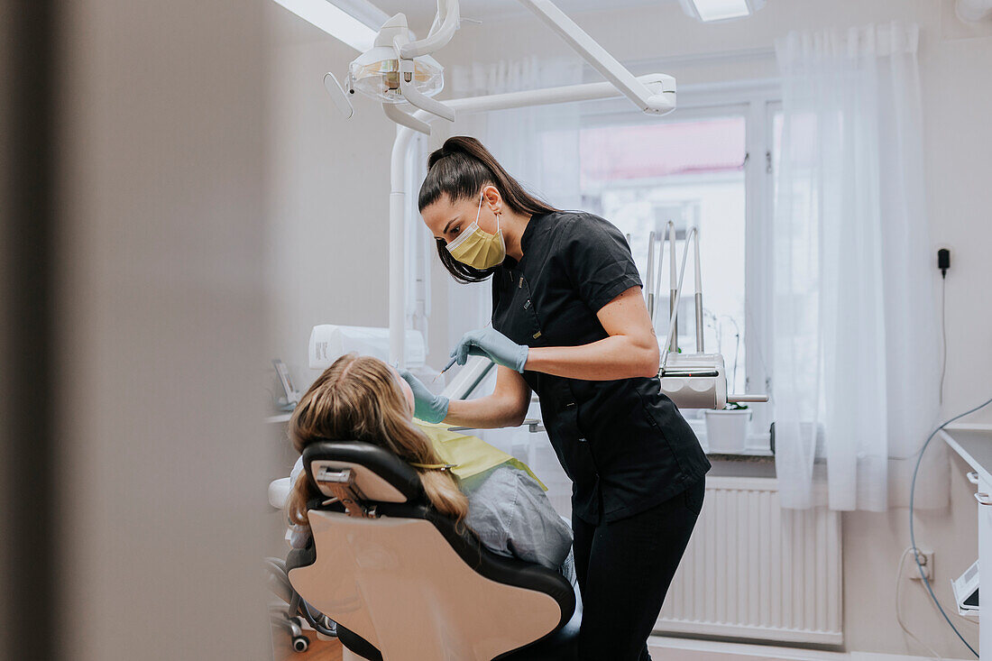 Female dentist with patient in dentist's office