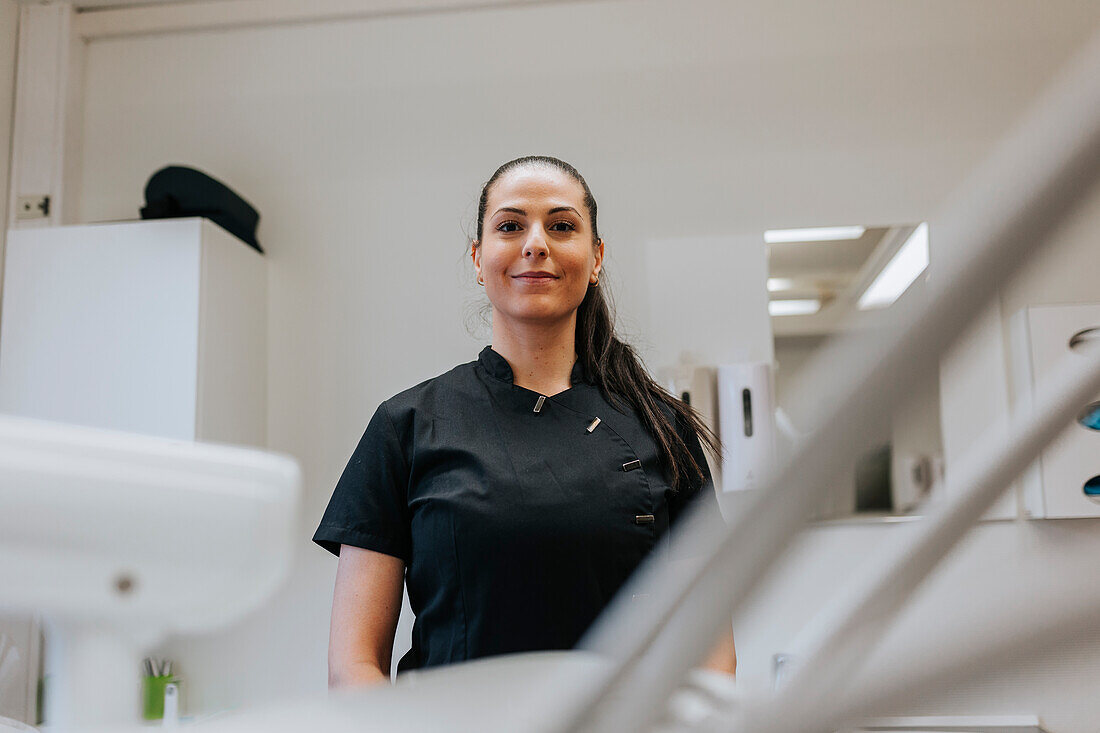 Female dentist standing in office