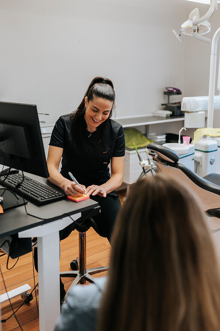 Female dentist using computer in office