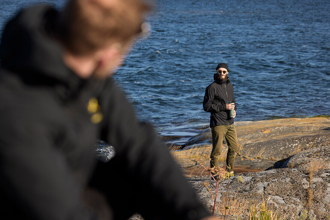 View of man standing at rocky coast