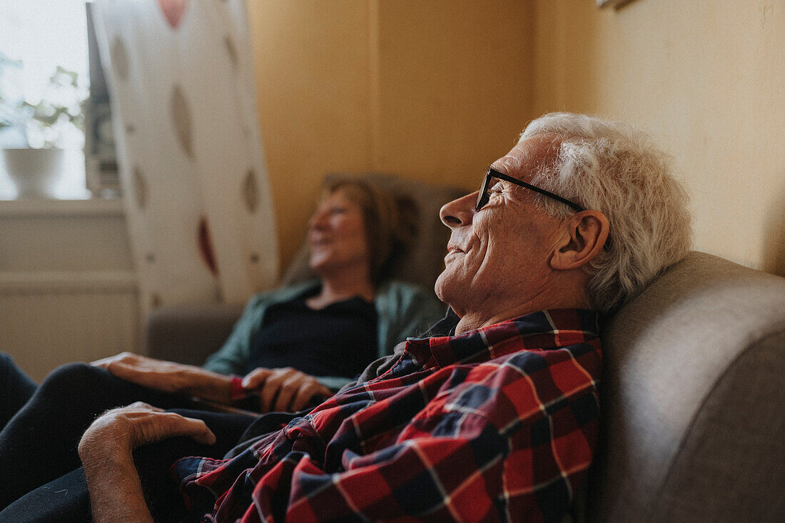 Senior couple relaxing on sofa