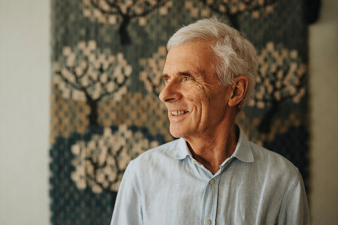 Smiling senior man at home