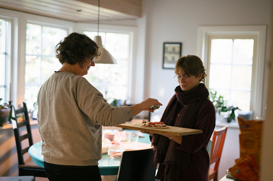 Mother and daughter preparing food at home