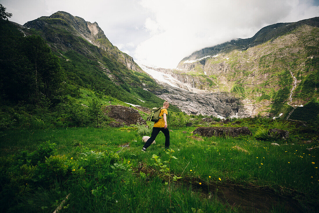 Woman hiking through meadow