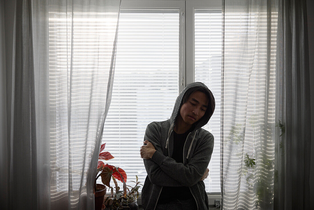 Man standing in front of window