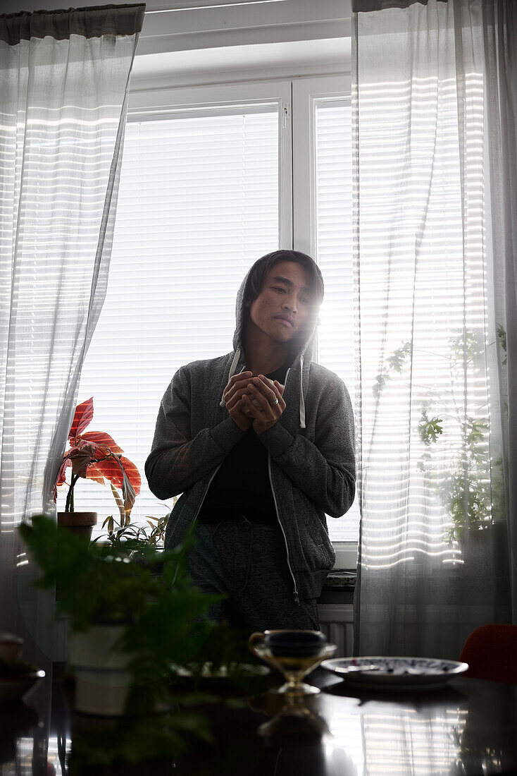 Man standing in front of window