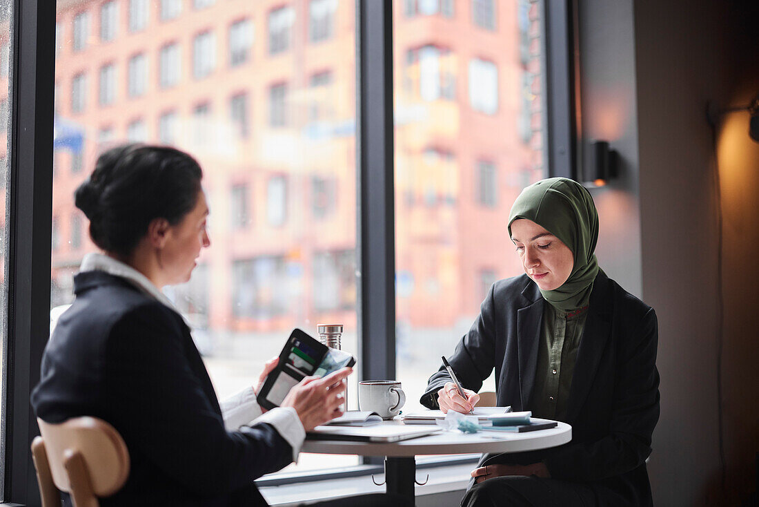 Smiling women sitting in cafe